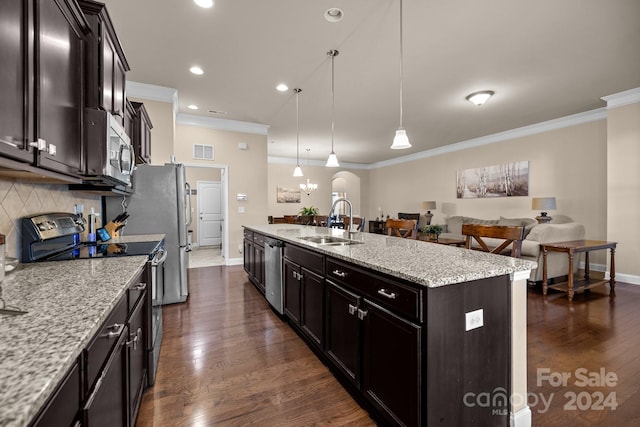 kitchen featuring pendant lighting, sink, dark hardwood / wood-style floors, an island with sink, and stainless steel appliances