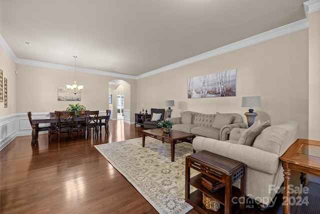 living room with crown molding, dark wood-type flooring, and a chandelier