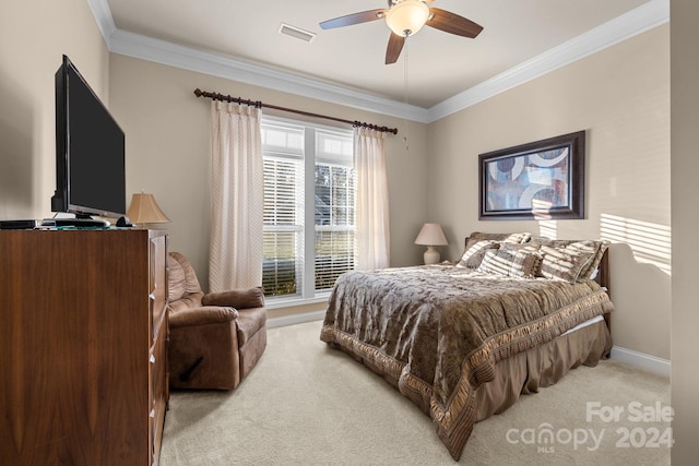 carpeted bedroom featuring ceiling fan and ornamental molding