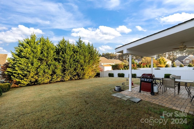 view of yard featuring ceiling fan and a patio area