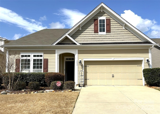 view of front of property with driveway and a garage