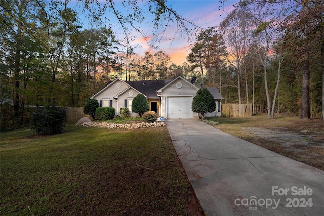 ranch-style house with a lawn and a garage