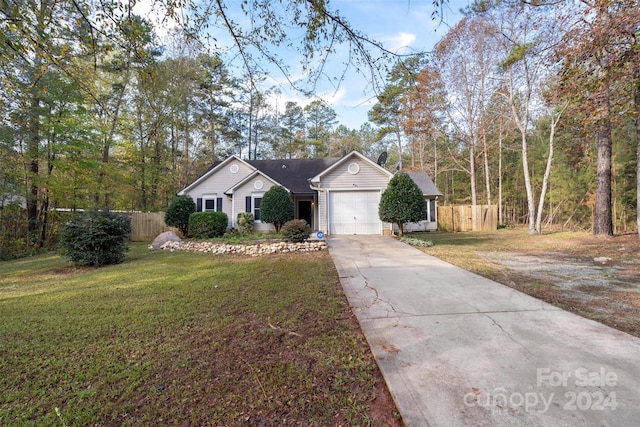 single story home featuring a garage and a front lawn