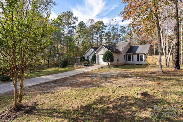 single story home with a garage and a front lawn