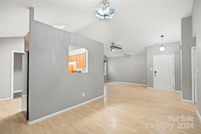 interior space featuring light hardwood / wood-style floors, vaulted ceiling, and ceiling fan