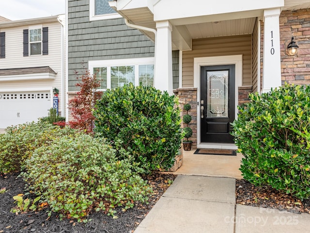 doorway to property with a garage