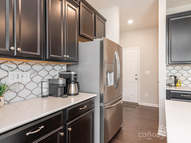 kitchen with backsplash, stainless steel fridge with ice dispenser, dark brown cabinets, and dark hardwood / wood-style floors