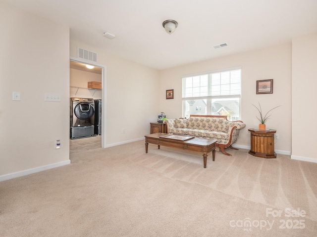 carpeted living room with separate washer and dryer