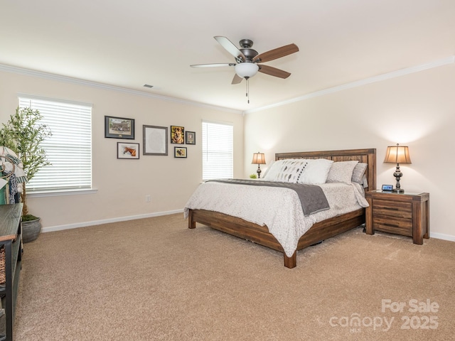 carpeted bedroom with ceiling fan and crown molding