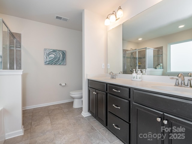 bathroom with an enclosed shower, vanity, and toilet