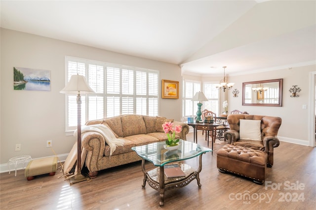 living room featuring hardwood / wood-style flooring, a wealth of natural light, and a chandelier