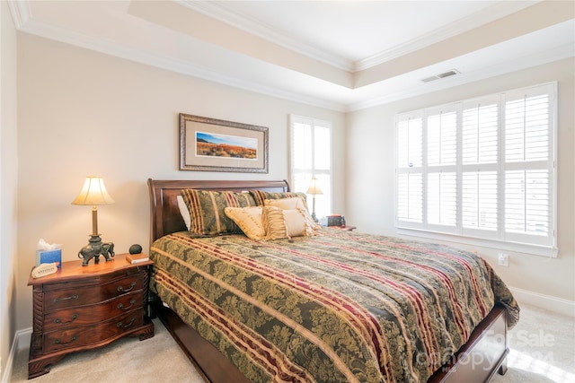 carpeted bedroom with a raised ceiling and ornamental molding