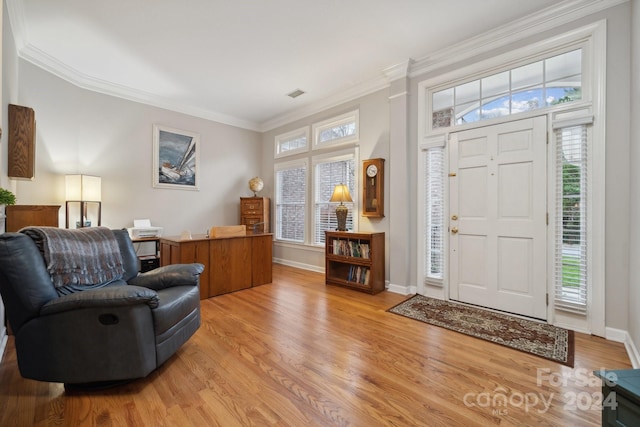 entrance foyer featuring crown molding and light hardwood / wood-style flooring