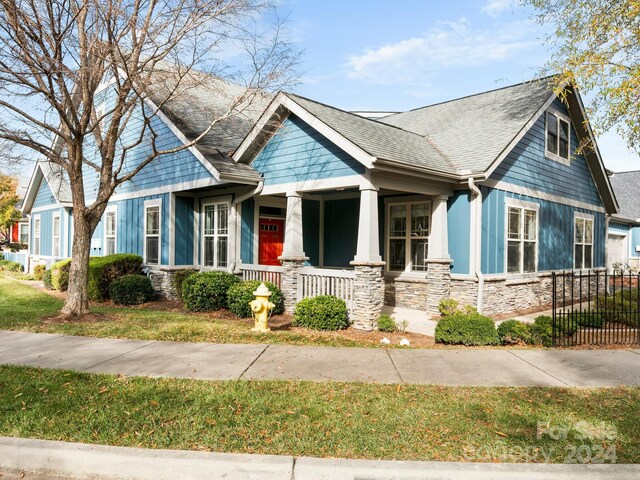 60 Westfield Way, Candler, NC 28715 - view of front facade with stone siding, a porch, and a shingled roof