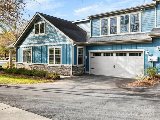 60 Westfield Way, Candler, NC 28715 - view of front of home with board and batten siding, stone siding, asphalt driveway, and an attached garage
