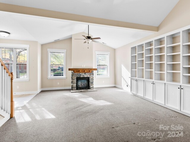 60 Westfield Way, Candler, NC 28715 - unfurnished living room featuring vaulted ceiling, carpet, baseboards, a stone fireplace, and a ceiling fan