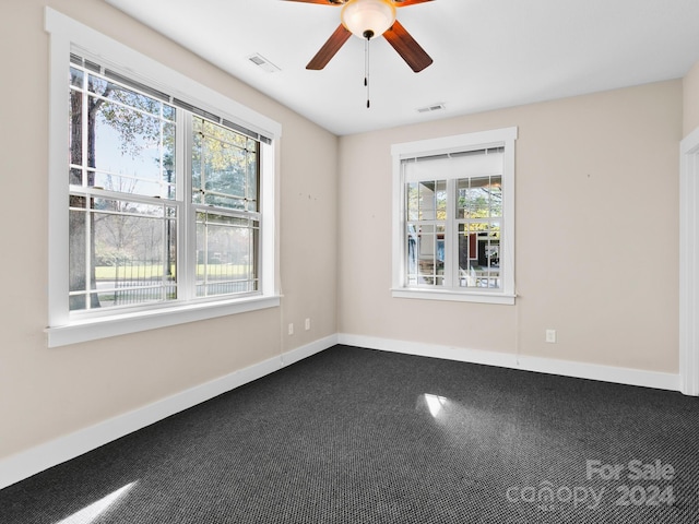 unfurnished room featuring carpet flooring, ceiling fan, and a healthy amount of sunlight