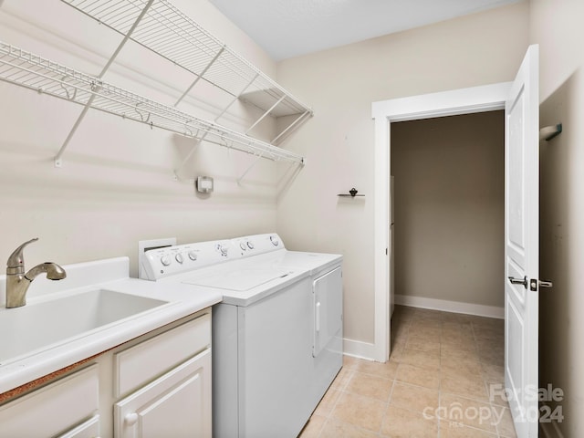 clothes washing area featuring light tile patterned flooring, sink, and washing machine and clothes dryer