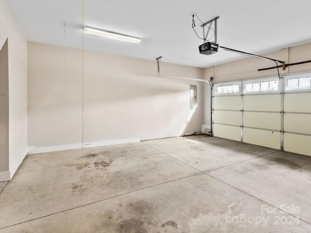 garage featuring electric panel and a garage door opener