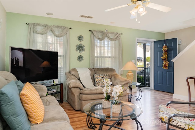 living room featuring light hardwood / wood-style flooring and ceiling fan