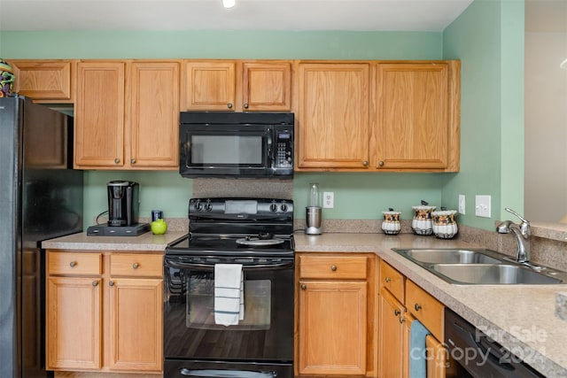 kitchen featuring light brown cabinets, sink, and black appliances