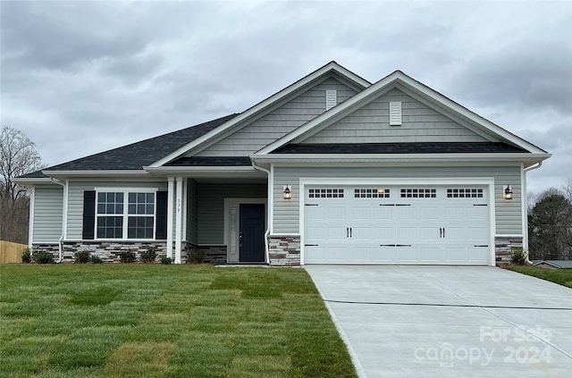 craftsman-style house with a garage and a front lawn