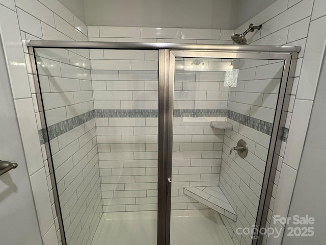 bathroom with a shower with shower door