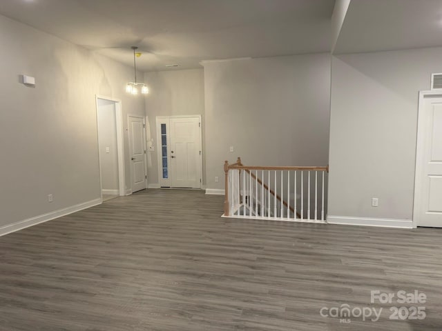 interior space featuring a notable chandelier and dark hardwood / wood-style flooring