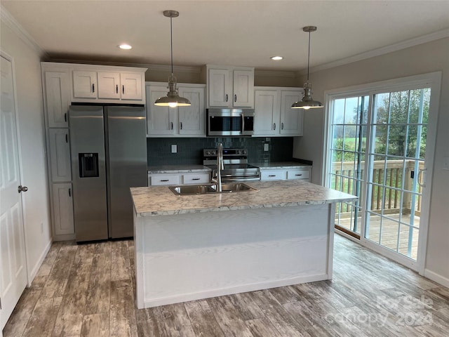 51 Rosemont Dr, Stony Point, NC 28678 - kitchen with stainless steel appliances, ornamental molding, decorative backsplash, baseboards, and an island with sink