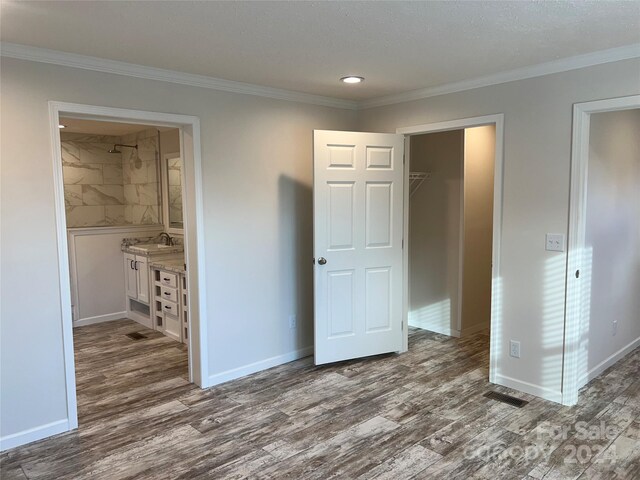 51 Rosemont Dr, Stony Point, NC 28678 - unfurnished bedroom with dark wood-style flooring, ornamental molding, baseboards, a sink, and ensuite bath