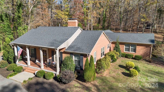 view of front of property with covered porch and a front lawn