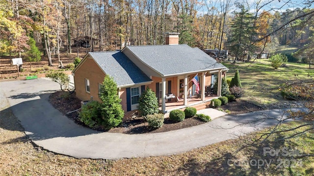 view of side of property featuring covered porch