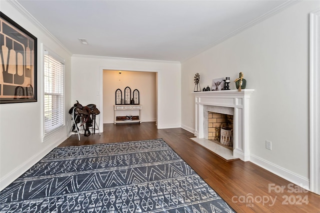 sitting room with dark hardwood / wood-style flooring and ornamental molding