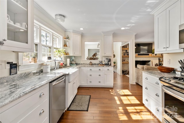 kitchen featuring white cabinets, light hardwood / wood-style floors, sink, and stainless steel appliances