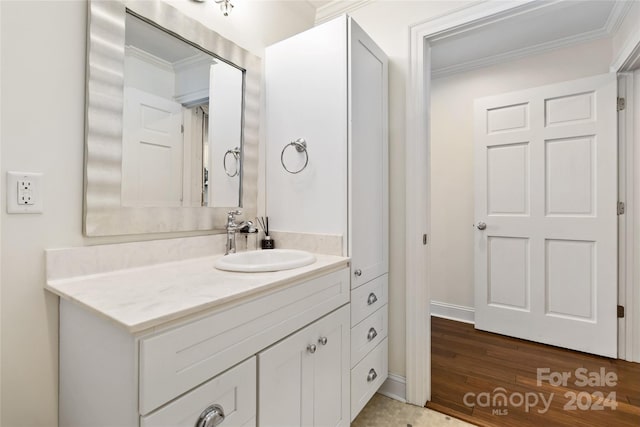 bathroom featuring hardwood / wood-style floors, vanity, and crown molding