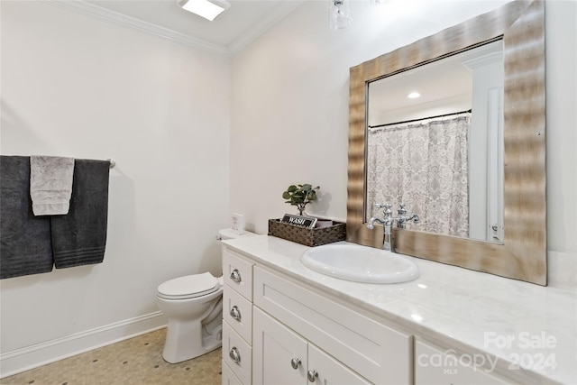 bathroom featuring vanity, toilet, and crown molding