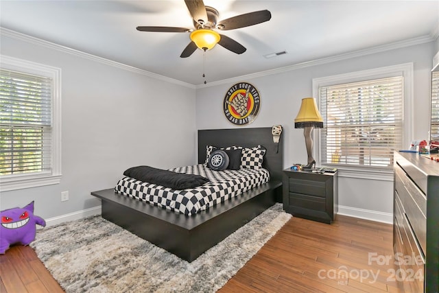 bedroom featuring hardwood / wood-style flooring, ceiling fan, and ornamental molding