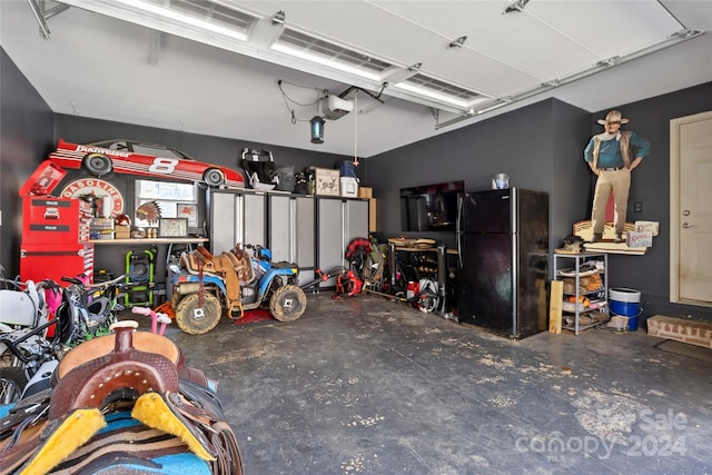 garage featuring black fridge and a garage door opener