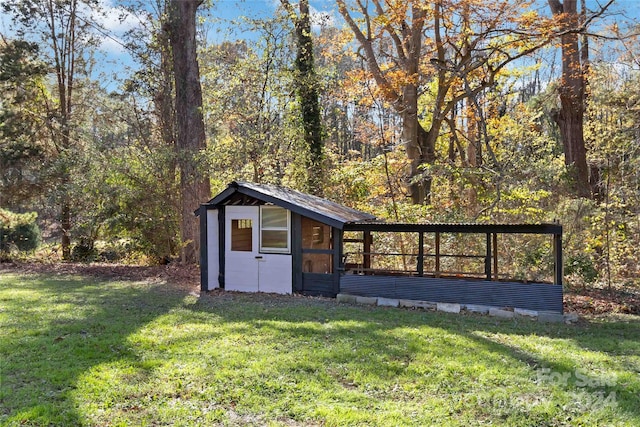 view of outbuilding with a lawn