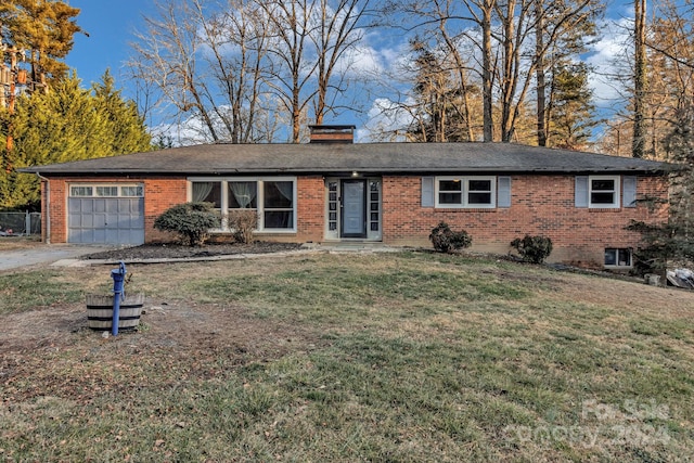 ranch-style house featuring a garage and a front lawn