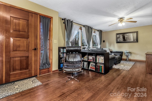 interior space featuring ceiling fan, hardwood / wood-style floors, and a textured ceiling