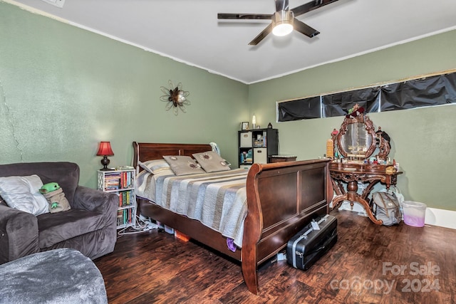 bedroom with crown molding, ceiling fan, and dark wood-type flooring