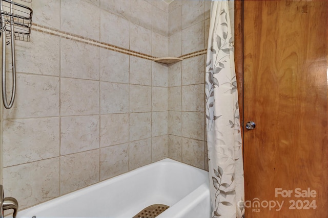 bathroom with shower / bath combination with curtain