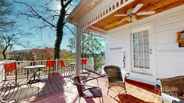 wooden deck with a porch and ceiling fan