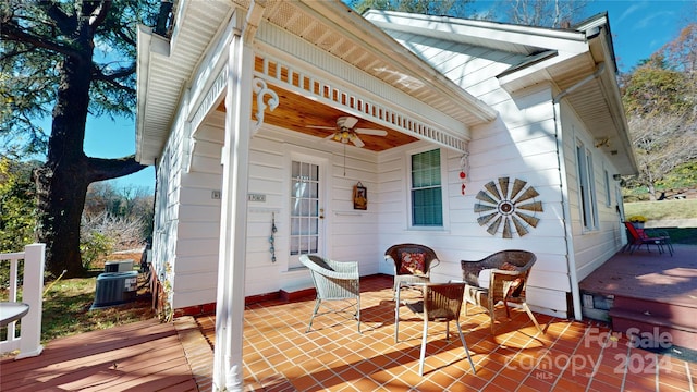 view of patio with a wooden deck, ceiling fan, and cooling unit