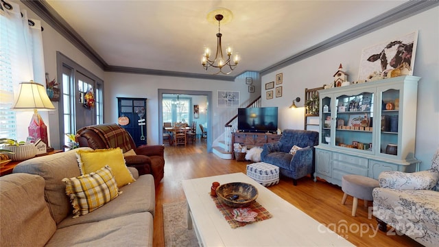 living room with a wealth of natural light, ornamental molding, and hardwood / wood-style flooring