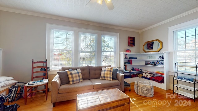 living room featuring ceiling fan, ornamental molding, and hardwood / wood-style flooring