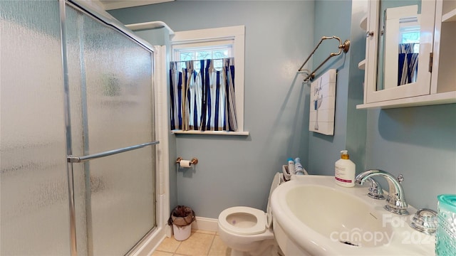 bathroom with toilet, tile patterned floors, a shower with shower door, and sink