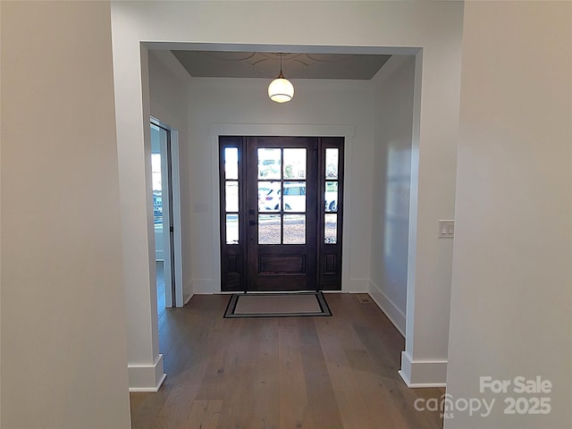 entryway with dark hardwood / wood-style flooring