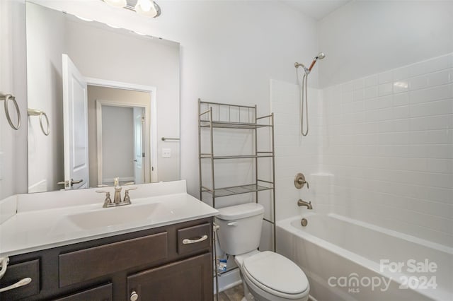 full bathroom featuring toilet, vanity, and tiled shower / bath